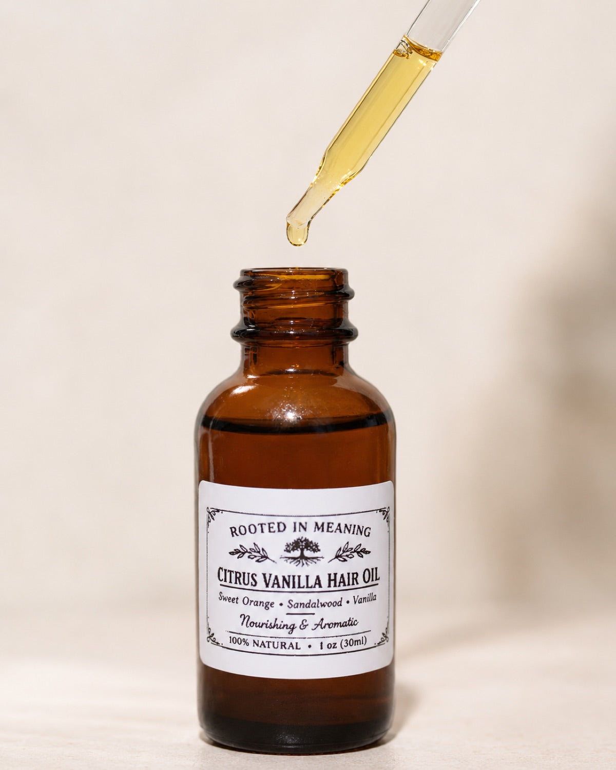 Citrus Vanilla hair oil bottle with dropper above the bottle